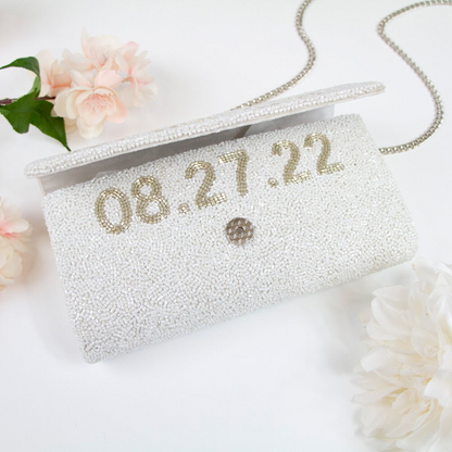 Handcrafted Custom Mrs (Last Name) Bridal Clutch, adorned with intricate beading and available with a gold or silver chain. Measuring 9.5in x 5in x 3in, this unique bridal clutch is perfect for holding wedding day essentials and offers an option for an interior custom date. Each clutch is a testament to the beauty and individuality of handmade items