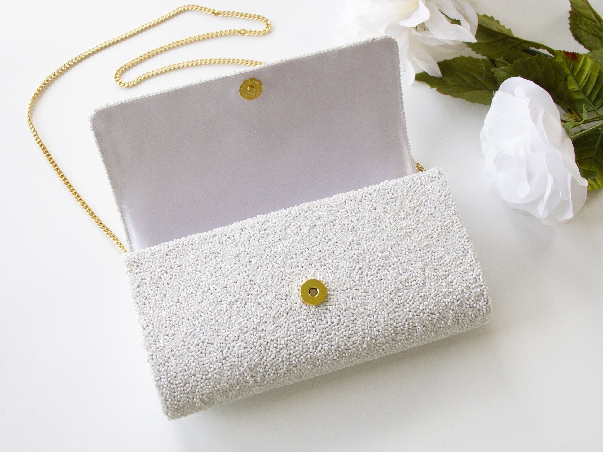 Elegant Bridal Clutch: Custom Gold Pearl Beaded Clutch Purse measuring 9.5in x 5in x 3in. Handcrafted to perfection, this bridal accessory adds a touch of sophistication to any ensemble. Each clutch is uniquely designed, ensuring brides have a one-of-a-kind accessory for their special day