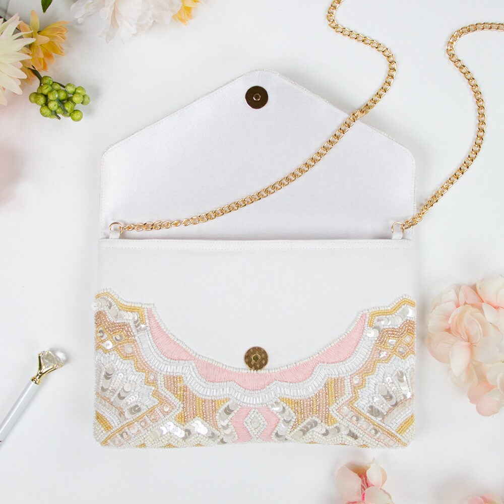 Elegant sequin beaded clutch with a vintage art deco design, ideal for brides and bridesmaids. Features gold chain, magnetic snap closure, and dimensions of 10in x 7in x 1.25in. Each handcrafted clutch is unique, making it a special gift for her