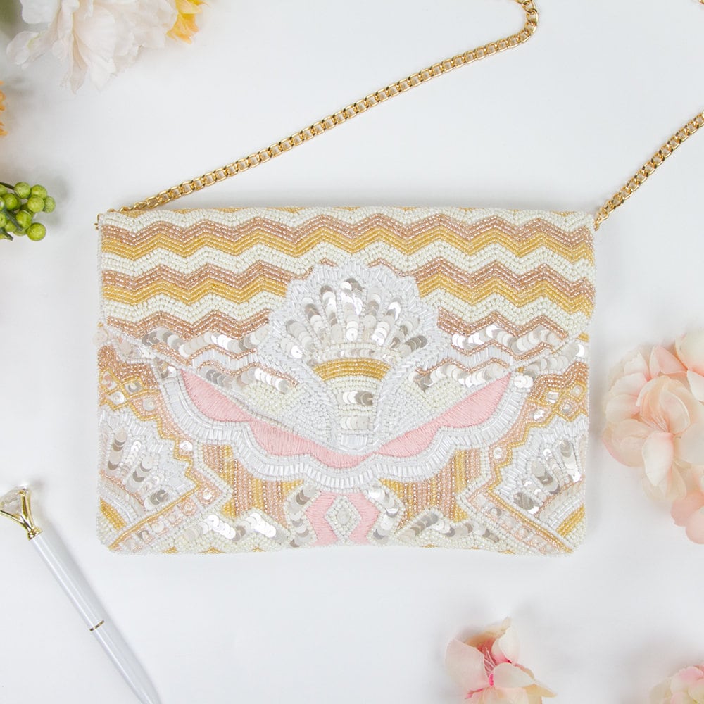 Elegant sequin beaded clutch with a vintage art deco design, ideal for brides and bridesmaids. Features gold chain, magnetic snap closure, and dimensions of 10in x 7in x 1.25in. Each handcrafted clutch is unique, making it a special gift for her