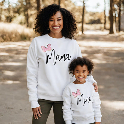 a woman and a child wearing matching sweatshirts
