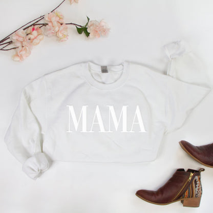 a white sweatshirt with the word mama printed on it