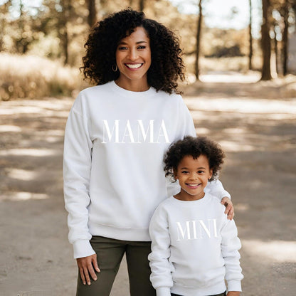 a woman and a child wearing matching sweatshirts