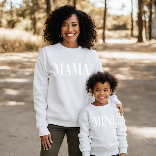 a woman and a child wearing matching sweatshirts